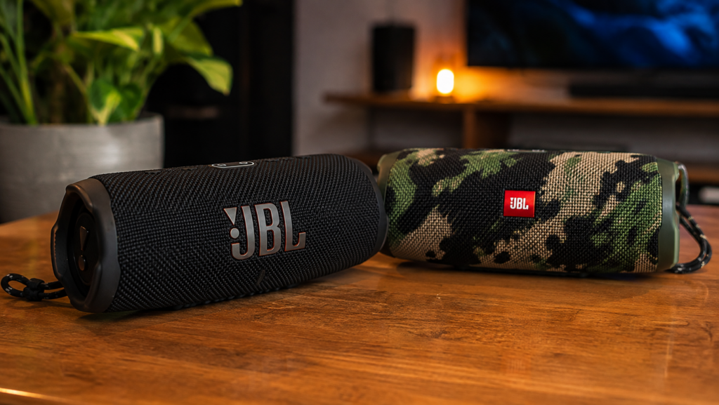 Two portable Bluetooth speakers in an audio-focused composition